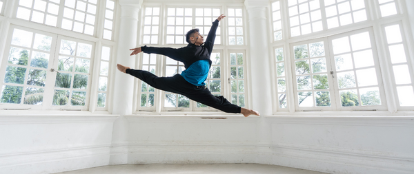 Dancer kevin in mid air jump split in rise cropped hoodie and freedom harem joggers