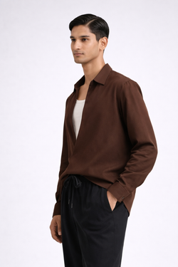 Man wearing a brown drop-V neckline, relaxed loose-fit long-sleeve top paired with black joggers