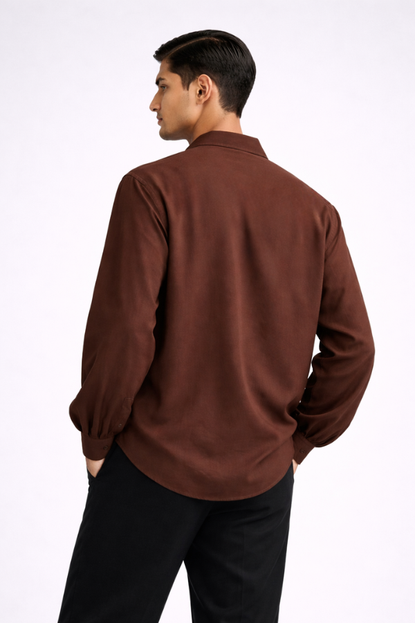 Man wearing a brown drop-V neckline, relaxed loose-fit long-sleeve top paired with black joggers