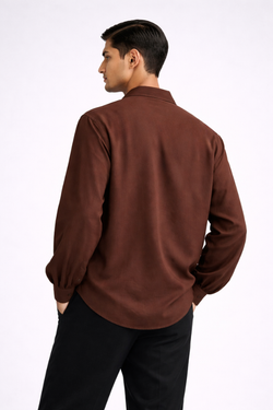 Man wearing a brown drop-V neckline, relaxed loose-fit long-sleeve top paired with black joggers