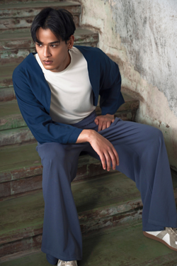 Finix FLOW Box Pleat Wide Leg Joggers in Shadow Blue – front view, model sitting.