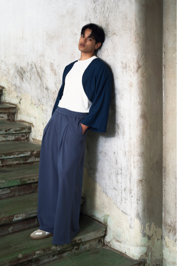 Finix FLOW Box Pleat Wide Leg Joggers in Shadow Blue – front view, model posing.