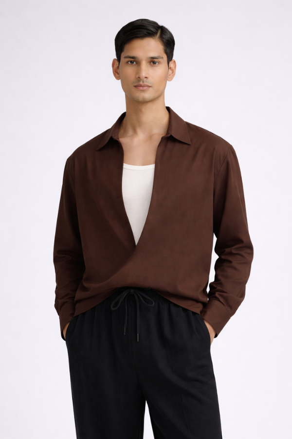 Man wearing a brown drop-V neckline, relaxed loose-fit long-sleeve top paired with black joggers